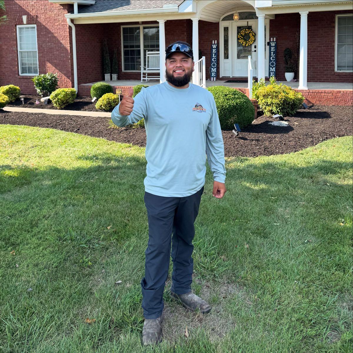 Johnny standing in front of a freshly mulched residential landscape bed